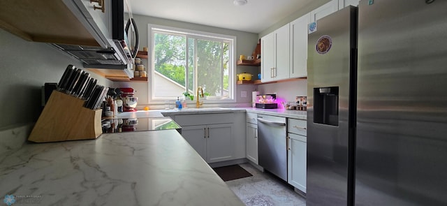 1442 11th Ave S, Fargo, ND 58103 - kitchen with stainless steel appliances, white cabinets, open shelves, a sink, and light stone counters