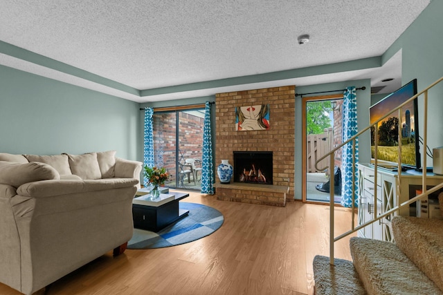 3625 Gettysburg Ave S Unit 40, Saint Louis Park, MN 55426 - living room featuring a textured ceiling, wood finished floors, stairway, and a fireplace