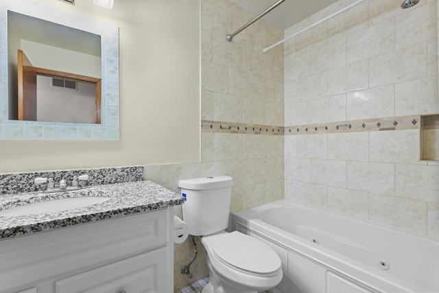 3625 Gettysburg Ave S Unit 40, Saint Louis Park, MN 55426 - full bathroom with tile walls, toilet, a combined bath / shower with jetted tub, and vanity