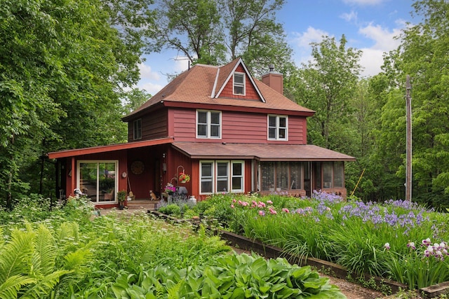 8482 150th St E, Northfield Twp, MN 55057 - view of front of property with a chimney, a sunroom, and roof with shingles