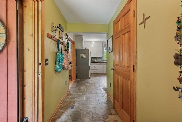 8482 150th St E, Northfield Twp, MN 55057 - hallway with stone tile flooring and baseboards
