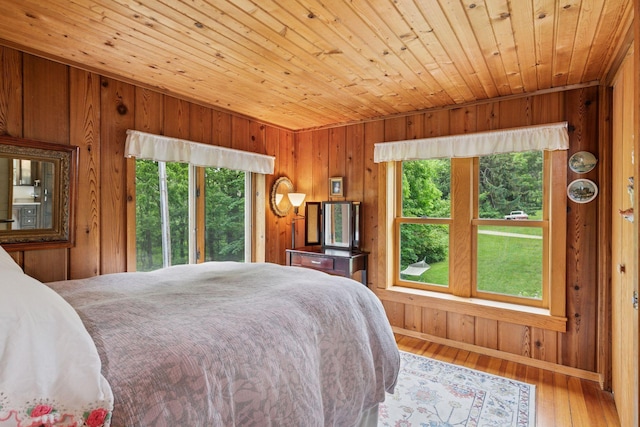 8482 150th St E, Northfield Twp, MN 55057 - bedroom with multiple windows, wood walls, wood ceiling, and wood finished floors