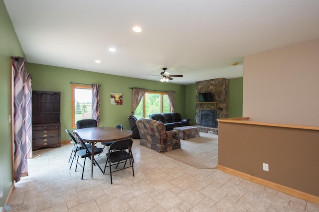 11905 Hunter Dr, Lake Park Twp, MN 56554 - dining room with a stone fireplace, a ceiling fan, recessed lighting, stone finish flooring, and baseboards