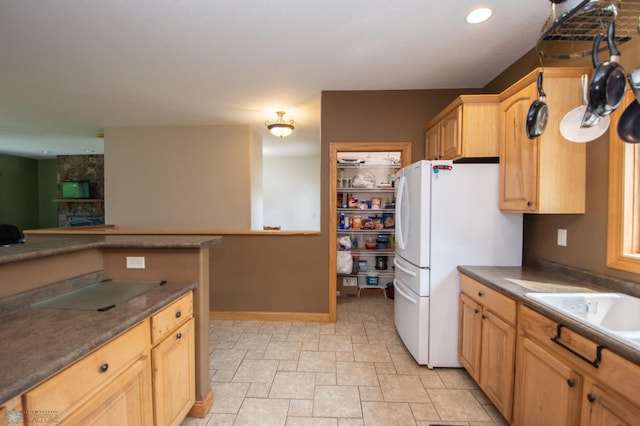 11905 Hunter Dr, Lake Park Twp, MN 56554 - kitchen featuring freestanding refrigerator, dark countertops, light brown cabinetry, recessed lighting, and a sink