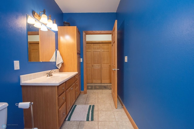11905 Hunter Dr, Lake Park Twp, MN 56554 - bathroom with vanity, toilet, tile patterned floors, and baseboards
