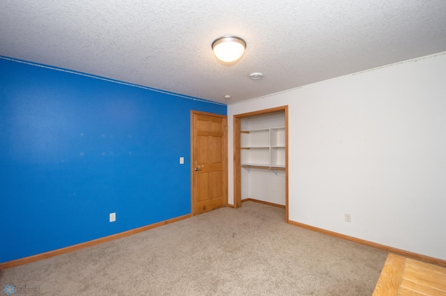 11905 Hunter Dr, Lake Park Twp, MN 56554 - unfurnished bedroom featuring a closet, a textured ceiling, baseboards, and carpet flooring