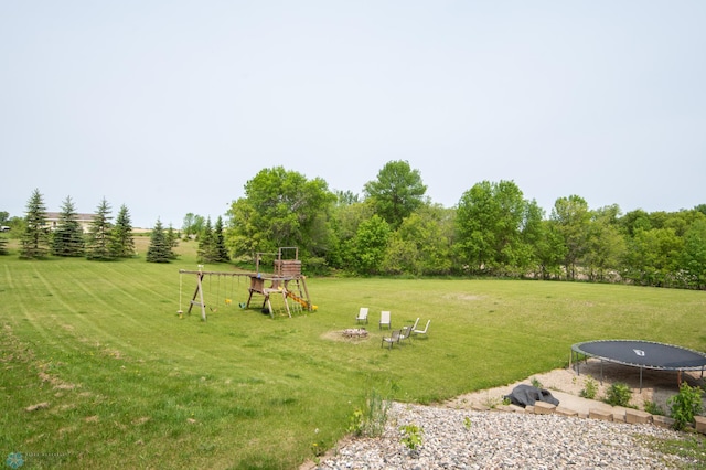 11905 Hunter Dr, Lake Park Twp, MN 56554 - view of grassy yard featuring a trampoline