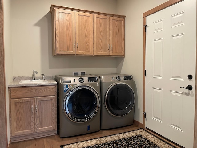 1504 3rd Ave N, Cold Spring, MN 56320 - laundry room with cabinet space, separate washer and dryer, and light wood-style floors