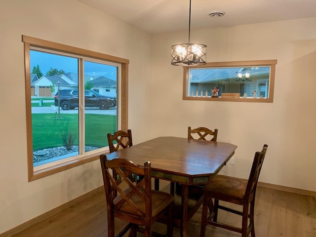 1504 3rd Ave N, Cold Spring, MN 56320 - dining area featuring wood finished floors, a chandelier, and healthy amount of natural light