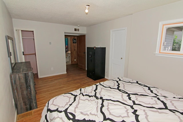 1979 Polaris Pl N, Saint Paul, MN 55109 - bedroom with wood finished floors and a textured ceiling
