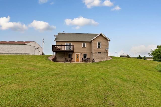 28145 State Highway 112, Le Sueur, MN 56058 - rear view of property featuring a lawn, a wooden deck, and a patio