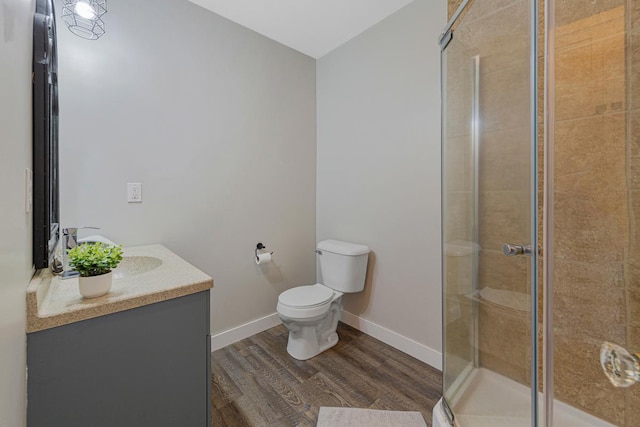 28145 State Highway 112, Le Sueur, MN 56058 - bathroom with toilet, wood finished floors, a stall shower, vanity, and baseboards