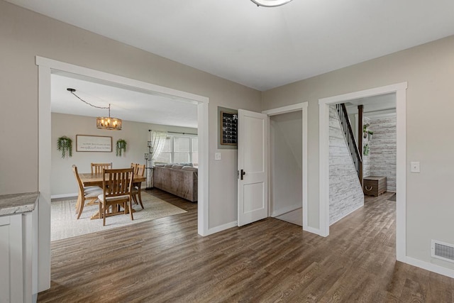 28145 State Highway 112, Le Sueur, MN 56058 - dining room with dark wood-type flooring, stairway, baseboards, and a chandelier