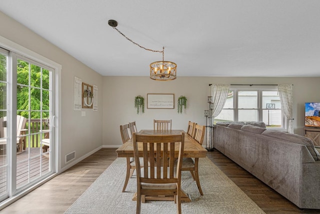 28145 State Highway 112, Le Sueur, MN 56058 - dining area featuring wood finished floors, a chandelier, and baseboards