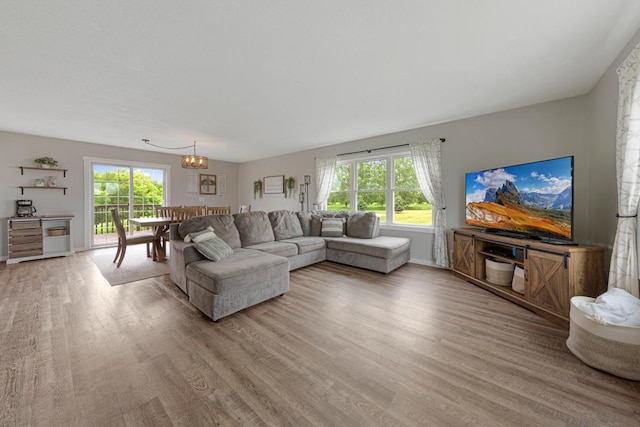 28145 State Highway 112, Le Sueur, MN 56058 - living area with light wood-style flooring, plenty of natural light, a chandelier, and baseboards