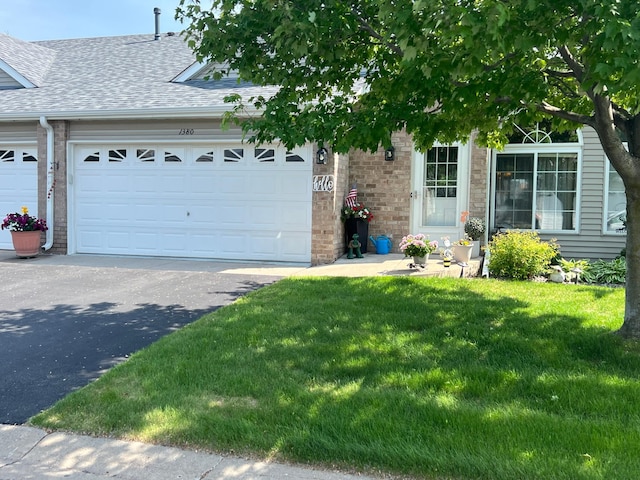 1380 129th Ln NE, Blaine, MN 55434 - view of front of property featuring brick siding, roof with shingles, an attached garage, and a front lawn