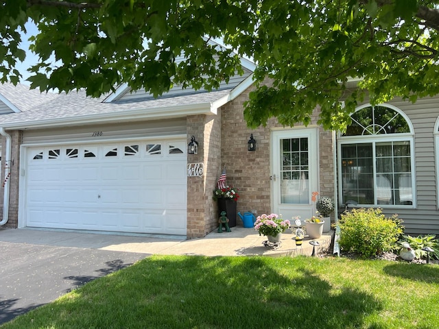 1380 129th Ln NE, Blaine, MN 55434 - ranch-style house featuring brick siding, a shingled roof, a front yard, and driveway