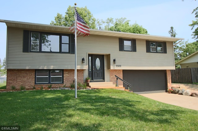 1322 17th St W, Hastings, MN 55033 - bi-level home with brick siding, an attached garage, and concrete driveway