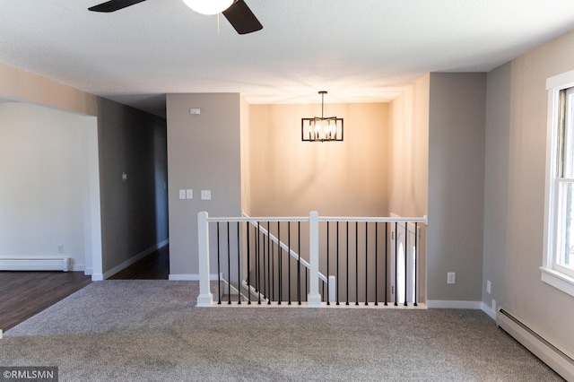 1322 17th St W, Hastings, MN 55033 - empty room with baseboard heating, a chandelier, carpet floors, and a ceiling fan