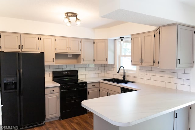 1322 17th St W, Hastings, MN 55033 - kitchen featuring black appliances, a sink, a peninsula, light countertops, and decorative backsplash