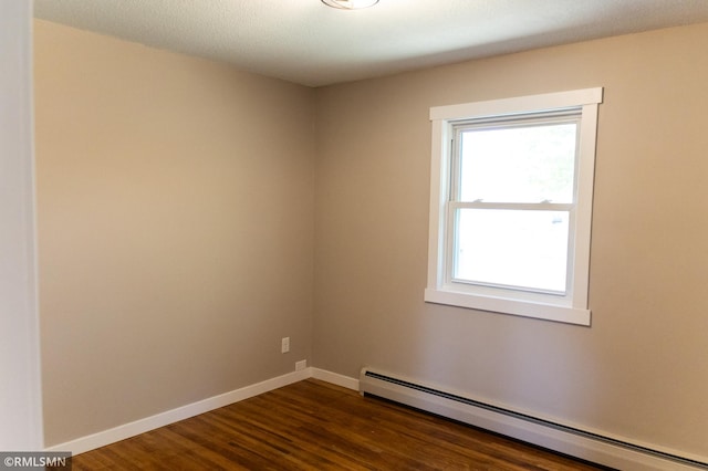 1322 17th St W, Hastings, MN 55033 - empty room with baseboard heating, dark wood-style floors, and baseboards