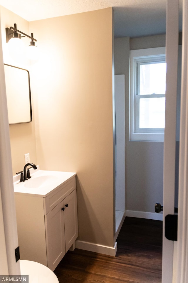 1322 17th St W, Hastings, MN 55033 - bathroom with vanity, wood finished floors, baseboards, and toilet