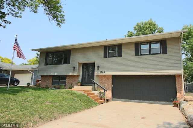 1322 17th St W, Hastings, MN 55033 - raised ranch with brick siding, a front lawn, an attached garage, and driveway