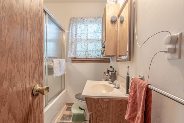 687 Jenks Ave, Saint Paul, MN 55106 - full bath featuring vanity, bath / shower combo with glass door, and toilet