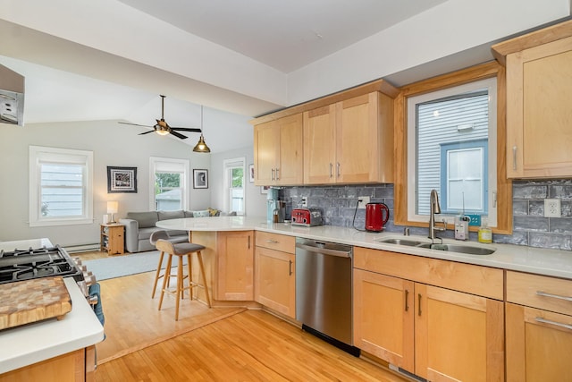 244 Macalester St, Saint Paul, MN 55105 - kitchen with stainless steel dishwasher, open floor plan, light brown cabinetry, a peninsula, and vaulted ceiling