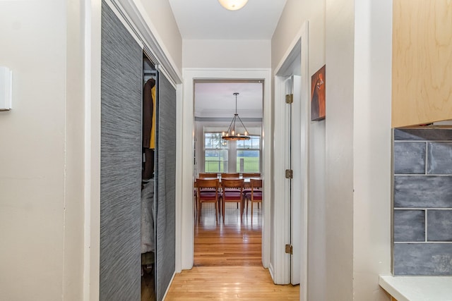 244 Macalester St, Saint Paul, MN 55105 - hallway with light wood-style flooring and a chandelier