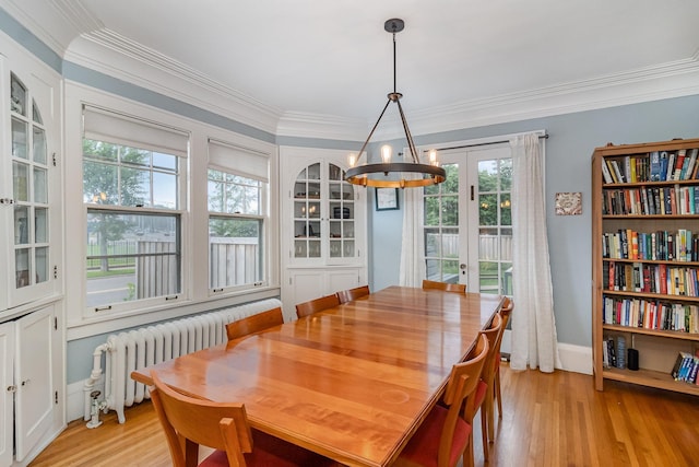 244 Macalester St, Saint Paul, MN 55105 - dining space with radiator heating unit, a chandelier, light wood-style flooring, ornamental molding, and french doors