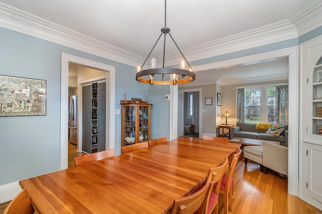 244 Macalester St, Saint Paul, MN 55105 - dining space with ornamental molding, a chandelier, and light wood-style flooring