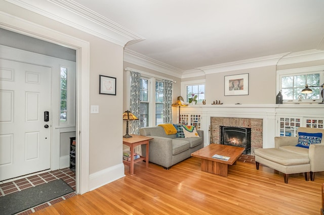 244 Macalester St, Saint Paul, MN 55105 - living area with light wood-style floors, a brick fireplace, and ornamental molding
