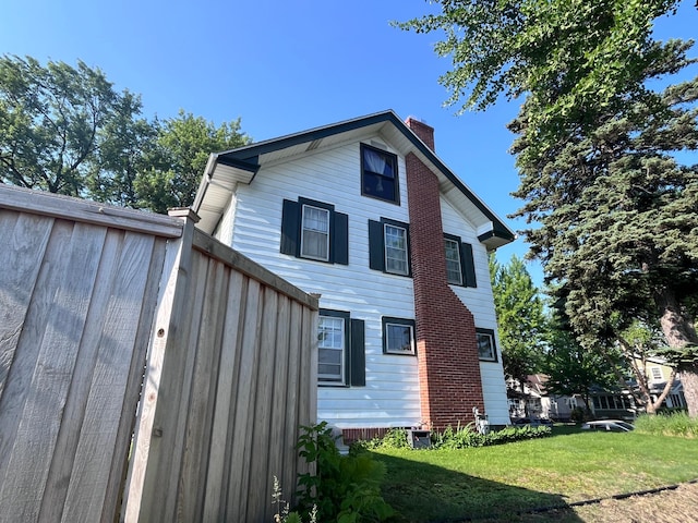 244 Macalester St, Saint Paul, MN 55105 - rear view of house with a chimney and a lawn