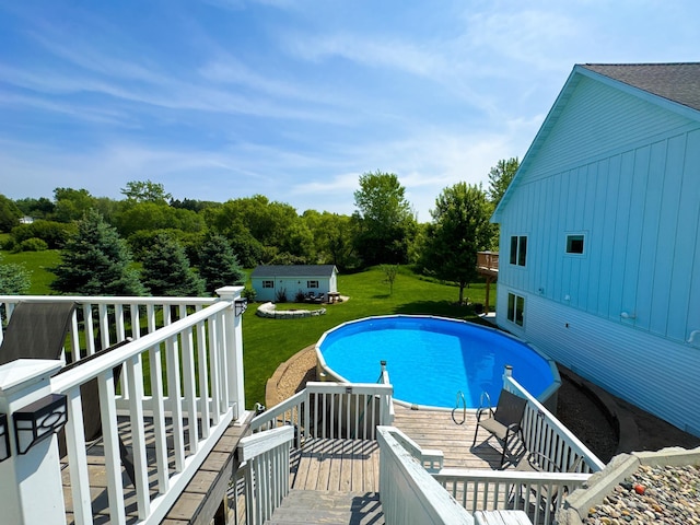 1207 Martin St, Fergus Falls, MN 56537 - outdoor pool featuring a lawn, a deck, and an outbuilding
