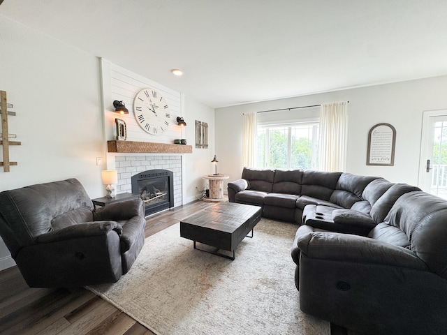 1207 Martin St, Fergus Falls, MN 56537 - living room with wood finished floors, healthy amount of natural light, and a brick fireplace