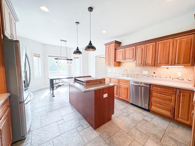 1207 Martin St, Fergus Falls, MN 56537 - kitchen featuring appliances with stainless steel finishes, a sink, stone tile floors, tasteful backsplash, and a center island