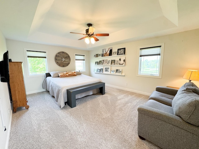 1207 Martin St, Fergus Falls, MN 56537 - carpeted bedroom with a raised ceiling, baseboards, and a ceiling fan