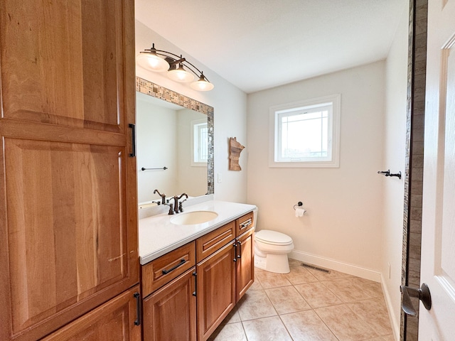 1207 Martin St, Fergus Falls, MN 56537 - bathroom featuring vanity, toilet, tile patterned floors, and baseboards