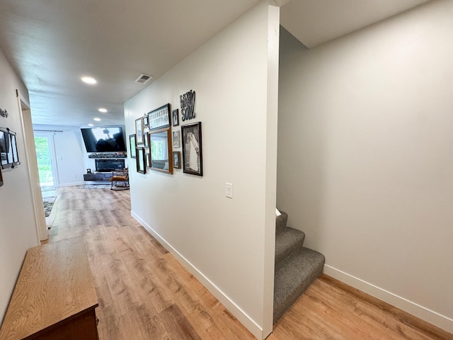 1207 Martin St, Fergus Falls, MN 56537 - hall with light wood-style floors, stairway, baseboards, and recessed lighting