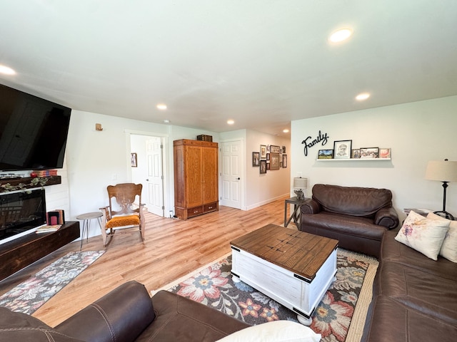 1207 Martin St, Fergus Falls, MN 56537 - living area featuring recessed lighting, light wood finished floors, a fireplace, and baseboards