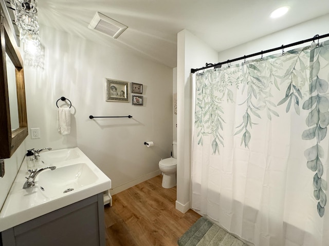 1207 Martin St, Fergus Falls, MN 56537 - full bathroom featuring wood finished floors, double vanity, toilet, shower / bath combination with curtain, and baseboards
