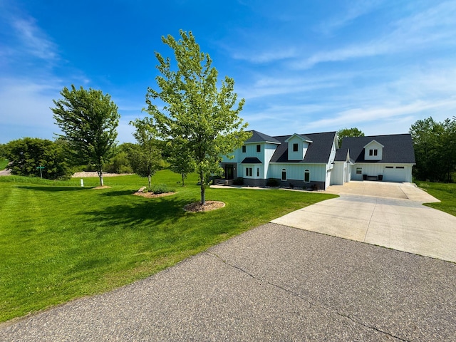 1207 Martin St, Fergus Falls, MN 56537 - view of front of home with concrete driveway, a front yard, an attached garage, and board and batten siding