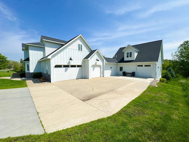1207 Martin St, Fergus Falls, MN 56537 - view of side of home with board and batten siding, a garage, concrete driveway, a yard, and a shingled roof
