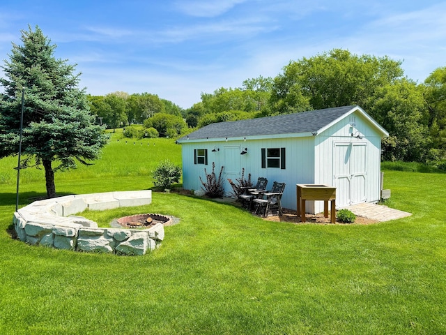 1207 Martin St, Fergus Falls, MN 56537 - back of property with a yard, an outdoor fire pit, view of scattered trees, and roof with shingles