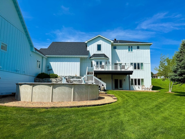 1207 Martin St, Fergus Falls, MN 56537 - rear view of property with a deck, board and batten siding, a yard, a shingled roof, and an outdoor pool