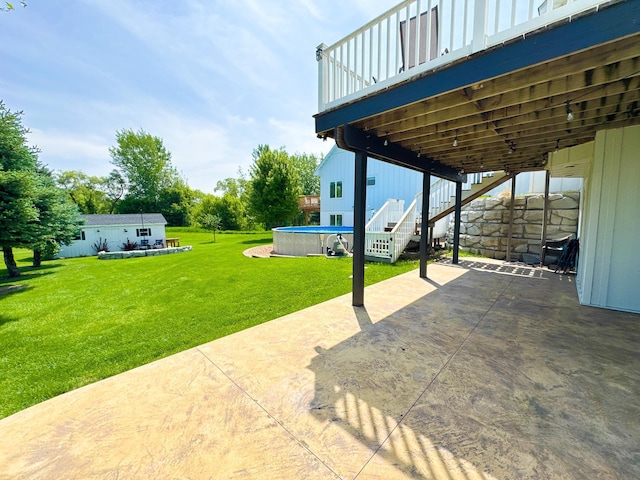 1207 Martin St, Fergus Falls, MN 56537 - view of patio with stairway, a deck, and an outdoor pool