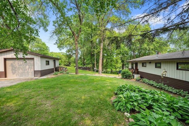 597 Emmet Rd, Lynden Twp, MN 55320 - view of grassy yard featuring an outdoor structure, driveway, and a garage
