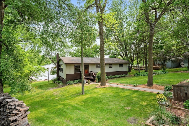 597 Emmet Rd, Lynden Twp, MN 55320 - rear view of house with a yard, a chimney, and roof with shingles