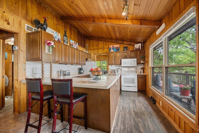 597 Emmet Rd, Lynden Twp, MN 55320 - kitchen featuring white appliances, wooden ceiling, light countertops, wood walls, and a sink